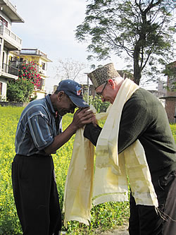 DaPhurey, the chief cook for the Pitzer in Nepal program, and Donahue exchanging prayer scarves.