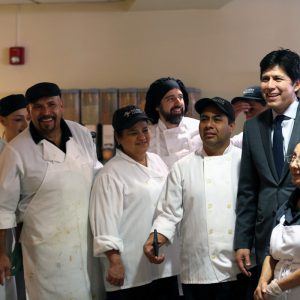 Kevin de Leon '03 meets with members of the dining hall staff.