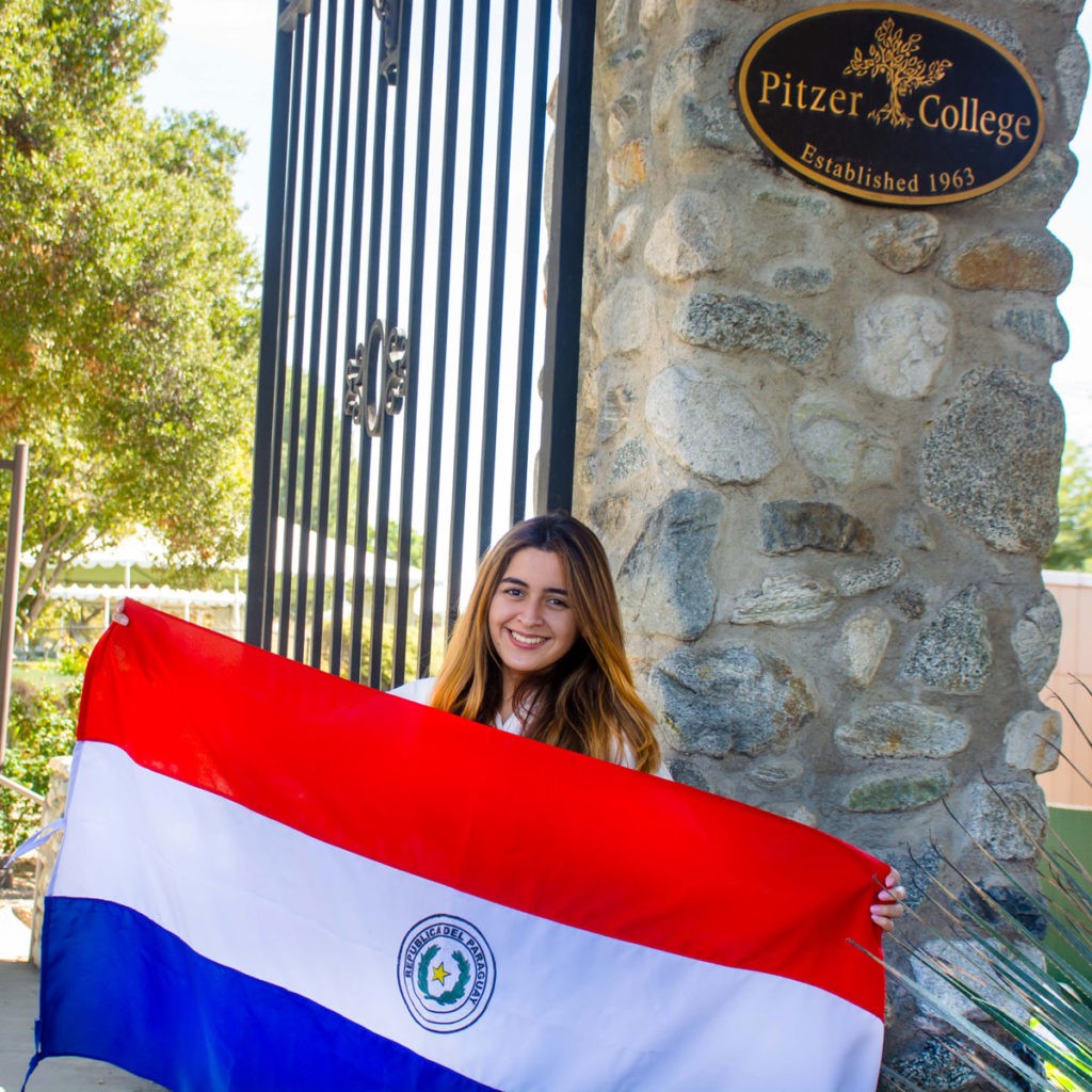 Diana Vicezar with a flag from her native country of Paraguay.