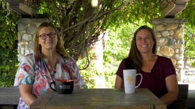 Kristin Williams and Stephanie Hannant sit with Pitzer mugs in the Grove House patio.