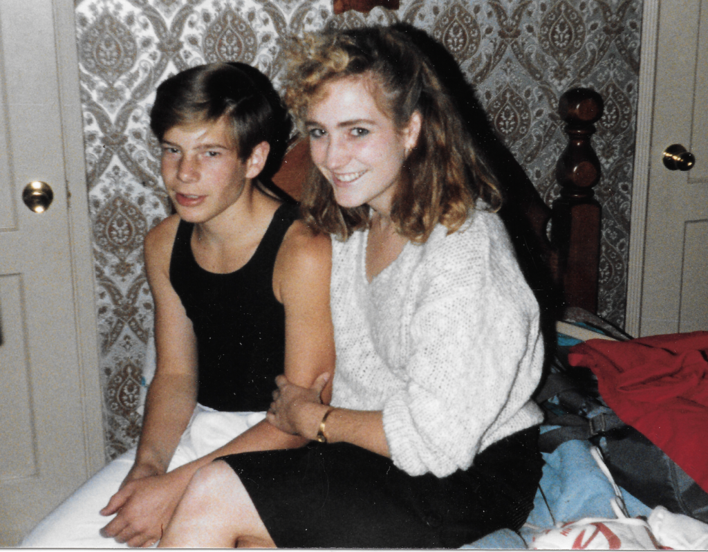 A photo taken in 1986 of Michelle Dowd seated next to her brother. The photo dates to the year she started at Pitzer.