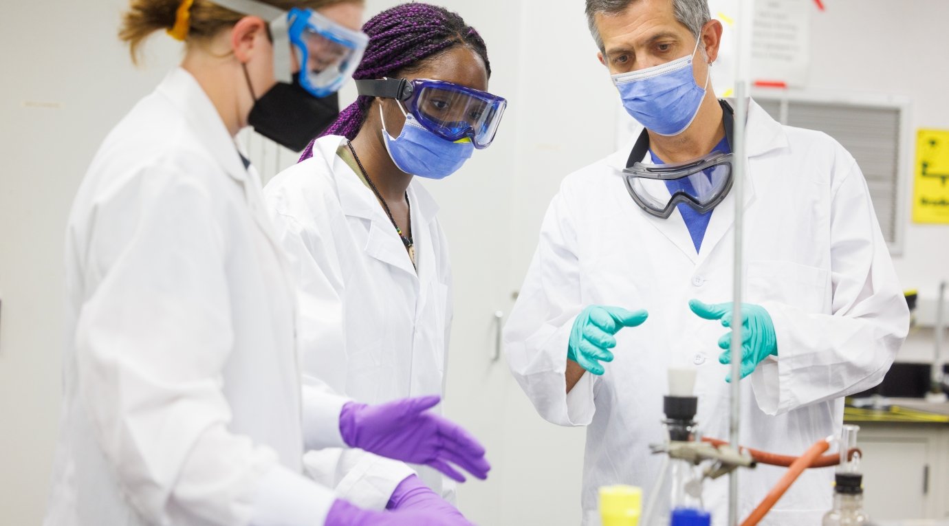 Students in a chemistry lab speak to their professor during a class at the Nucleus