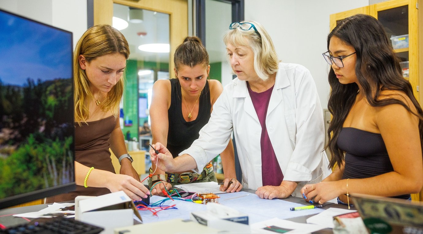 Students look on as a professor performs a demonstration