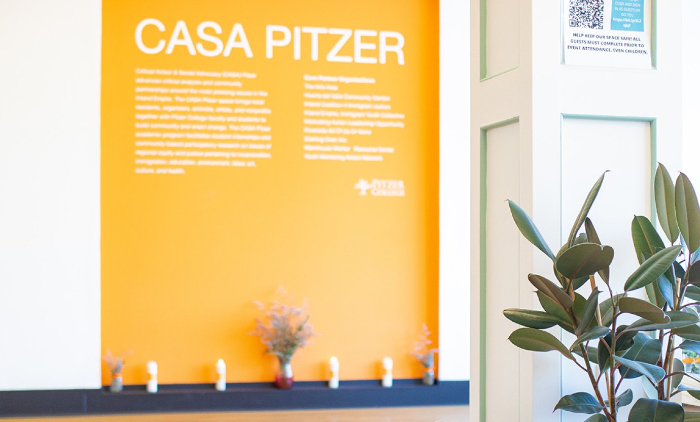 The CASA orange wall with CASA PITZER at the top. 
