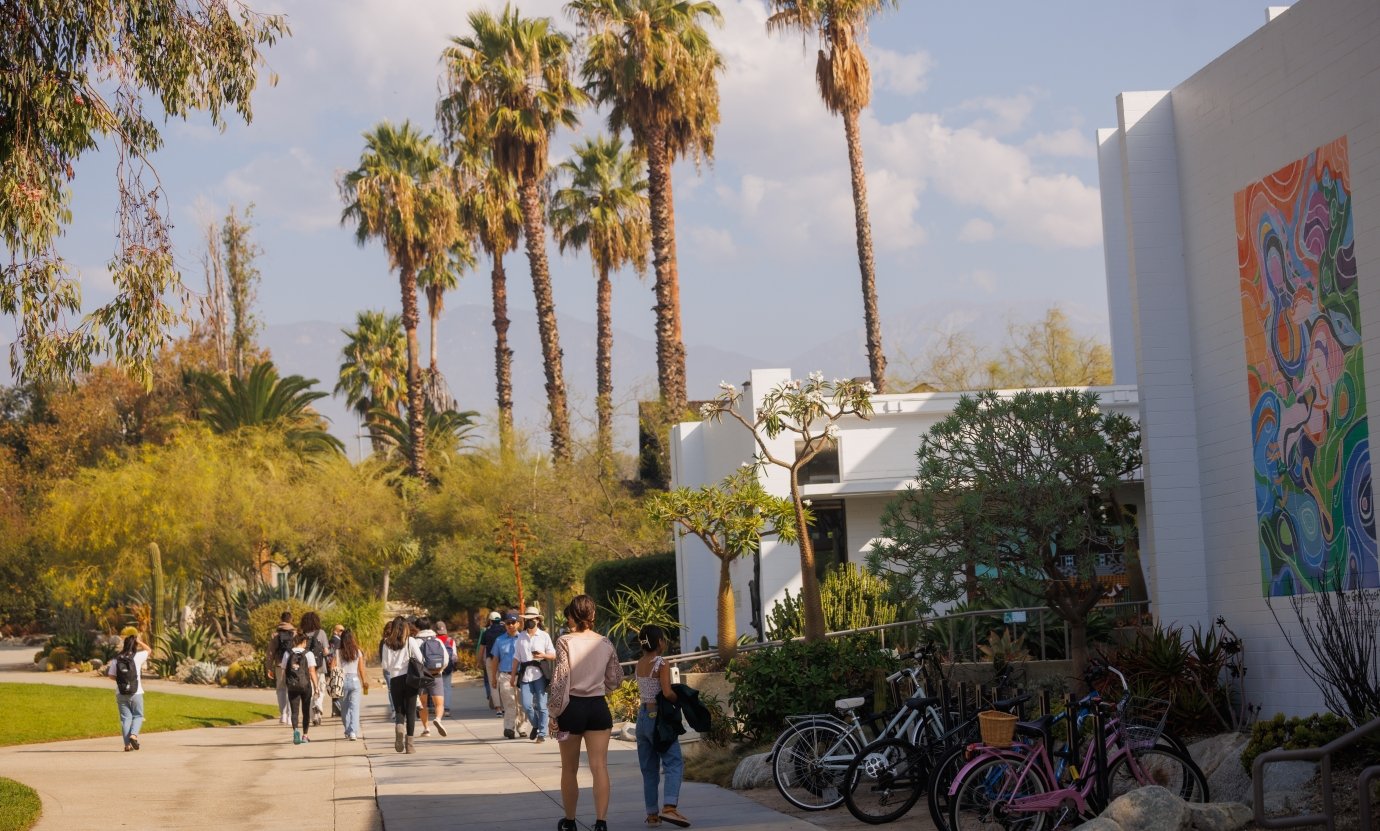 Wide campus view of people walking.