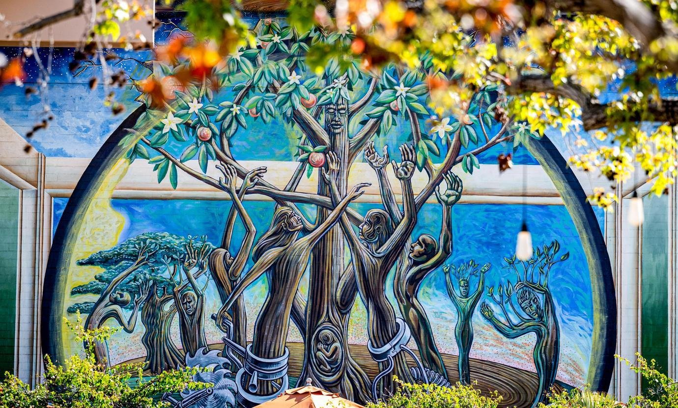 tree of life mural featuring tree trunks in the shape of human forms