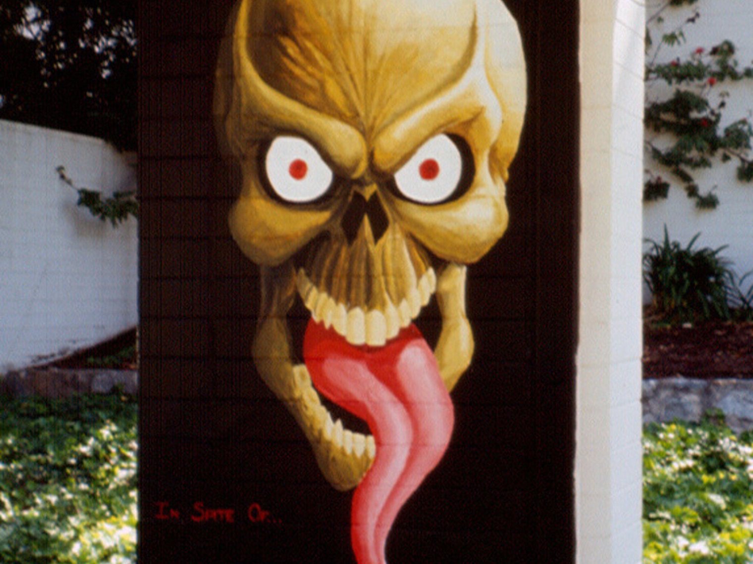 mural of a monster face with an snake tongue on a black background