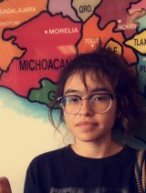 Professor Debbie Duarte standing in front of a map