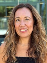 head shot of jaylene shoji standing in front of an office building