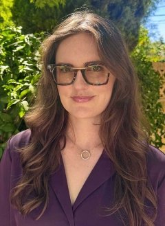 headshot of leah senatro wearing glasses and a dark purple blouse
