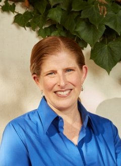 Woman with blue top with red hair.