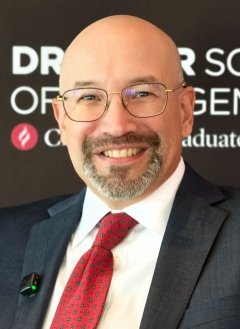 headshot of Adrian Pantoja wearing a white collared shirt, red tied, and black blazer