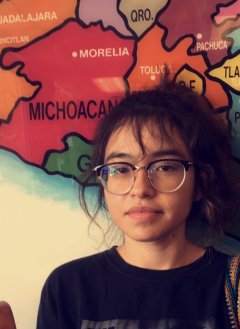 Professor Debbie Duarte standing in front of a map