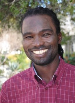 Smiling man with a pink checkered shirt