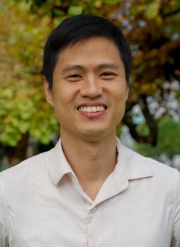 Closeup of Ahn Pan, who has short straight black hair and wears a white collared shirt.
