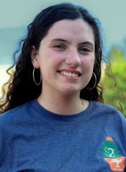 portrait of kaitlyn o'conner wearing a blue strive to thrive shirt
