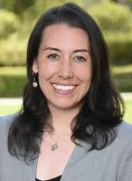 Violet Luxton Pitzer staff member portrait with greenery in the background.
