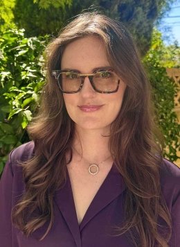 headshot of leah senatro wearing glasses and a dark purple blouse
