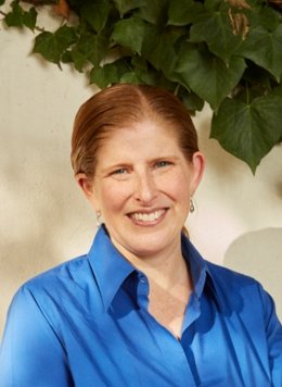 Woman with blue top with red hair.