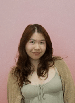 Iris Huang standing in front of a pink wall