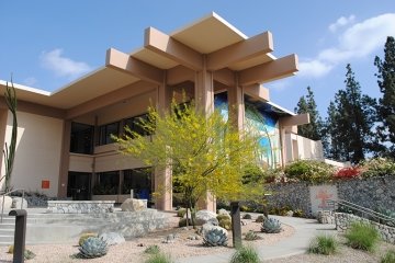 An outside view of the west side of McConnell surrounded by a desert landscape