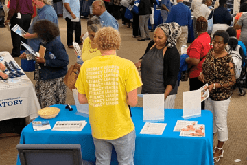 participants visit a table at a resource fair