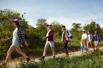 a group of students hike down a path