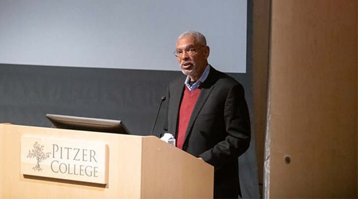 Melvin L. Oliver stands at the podium in Pitzer's Benson auditorium.