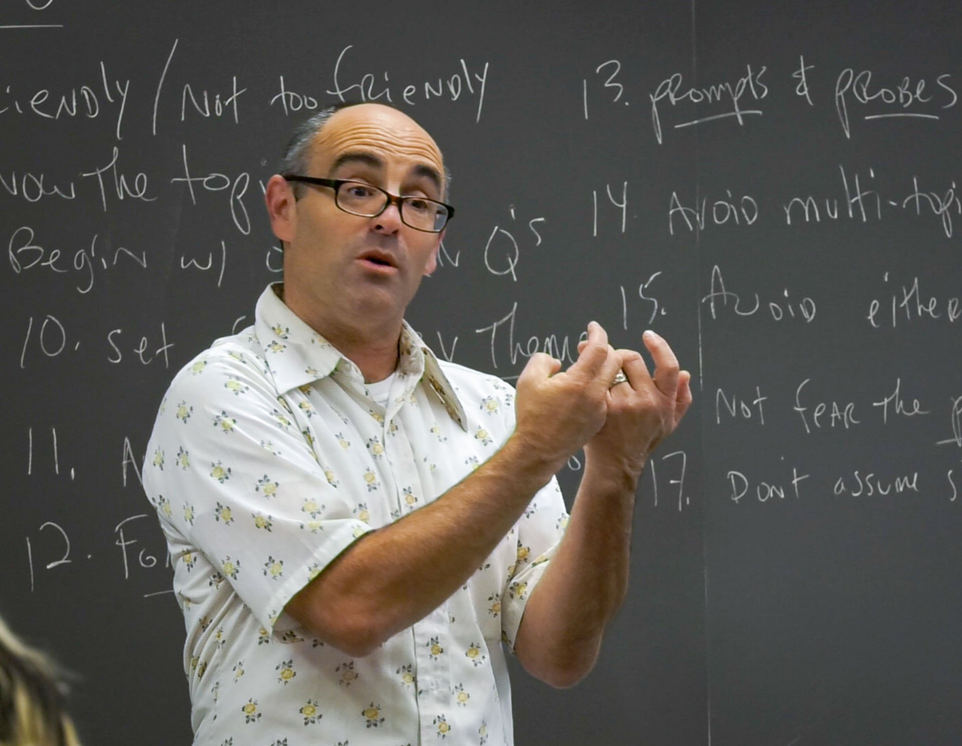 phil zuckerman lectures in a classroom while being filmed