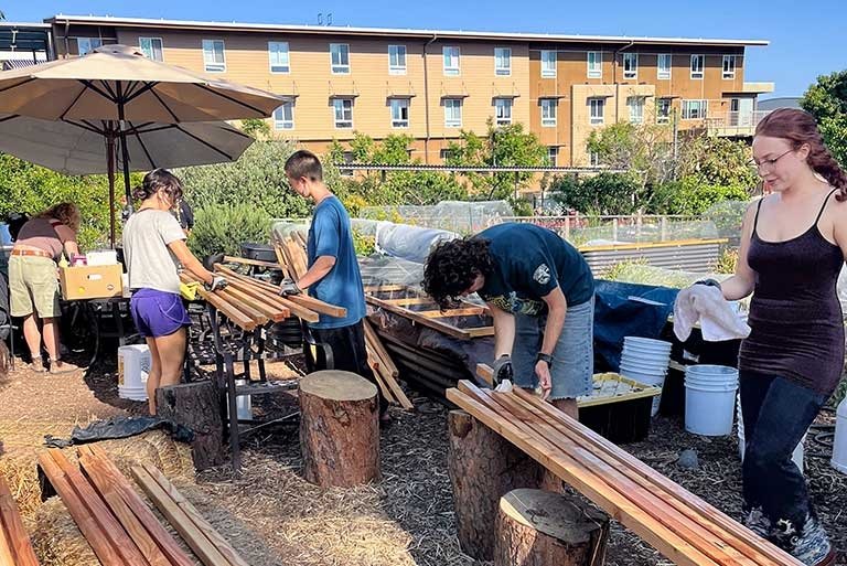 Pitzer students work in the student garden on Earth Day