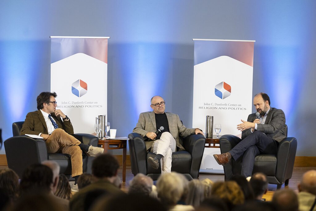 Phil Zuckerberg sits on a stage with two guests