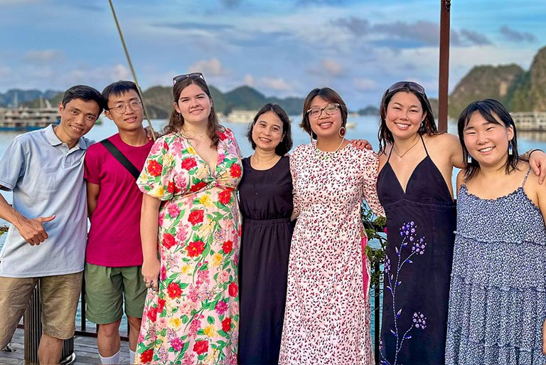 a group of students pose in front of Ha Long Bay