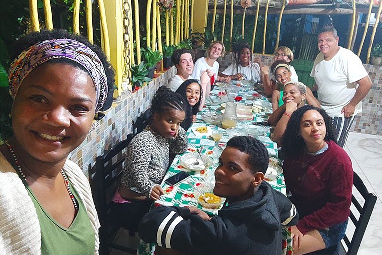 a group of students sit around a table during their time in Brazil