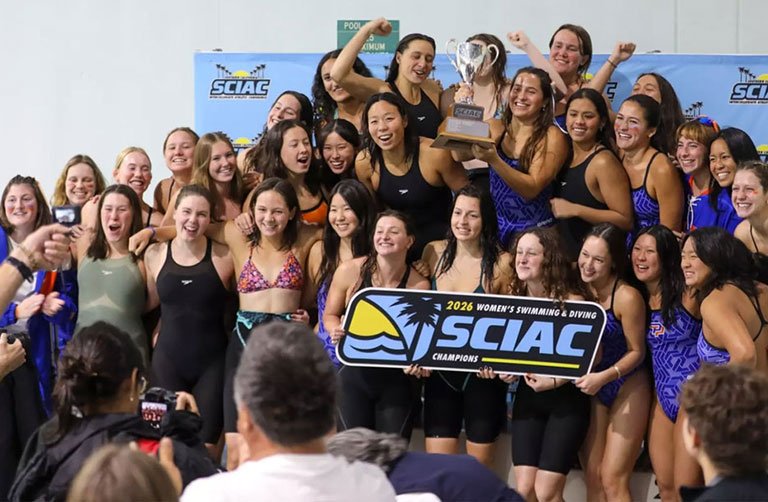 the women's swim team pose with the 2026 SCIAC champions sign