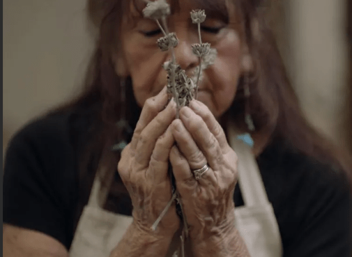 Barbara Drake holding native plants