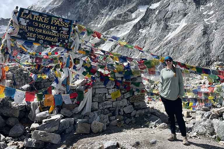 student stands at Larke Pass in Nepal