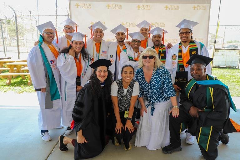 Students from the CRC pose in their graduation caps and gowns, along with members of the Pitzer JEC staff