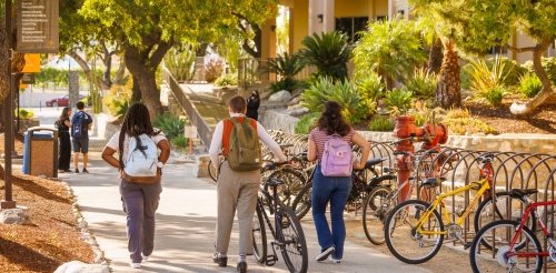 Students walk their bikes down the Avery walkway