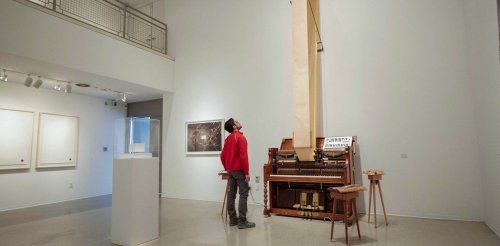 Student observes art in teh gallery