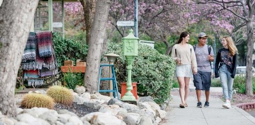 three students walk in the Claremont Village