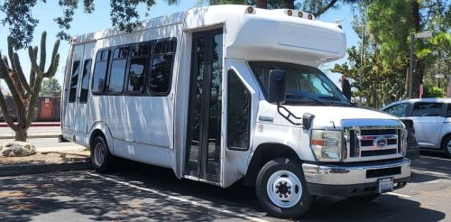 a white sagehen shuttle is parked in the mesa parking lot