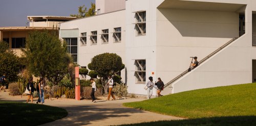 several students leave broad hall building after class
