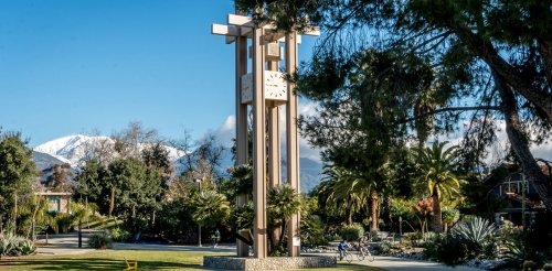 a view of the clock tower with the grove house in the background