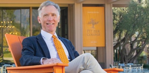 strom thacker sits on the mounds in front of McConnell Center