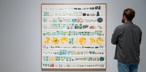 A person looks at a collection of artifacts from Gala Porras Kim's exhibition “Between Lapses of Histories”
