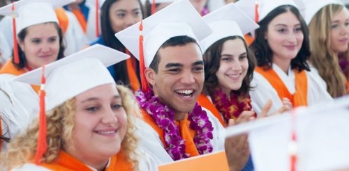 graduates laugh during commencement ceremony