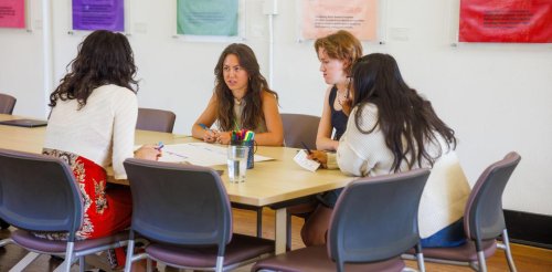 Students work at a table at CASA Pitzer