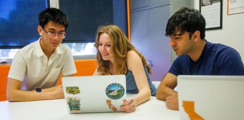 Students work on their laptops in the Career Services office