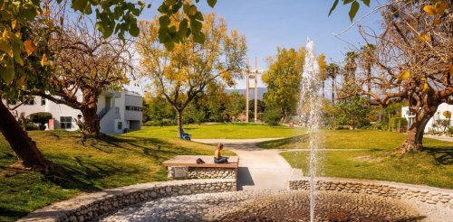 a student sits near the pitzer fountain