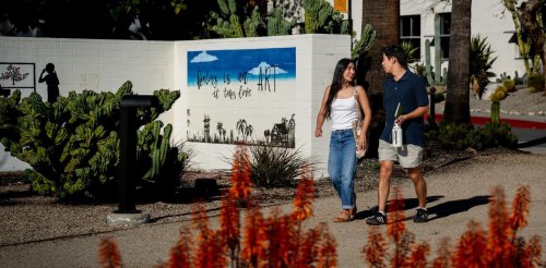 two students walk through Holden Garden